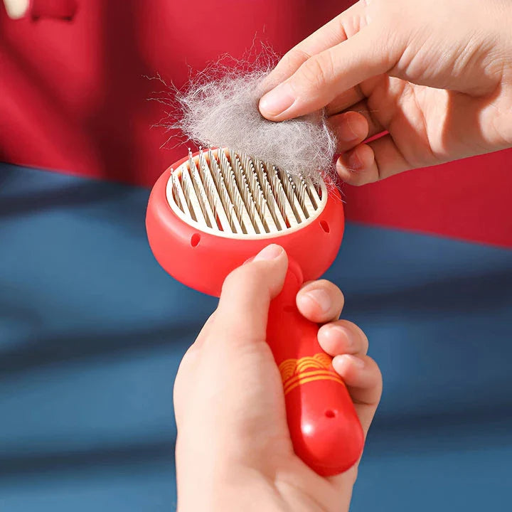 One-Click Pet Hair Removal Comb in red colour, designed to effectively remove loose fur and tangles from cat or dog coats