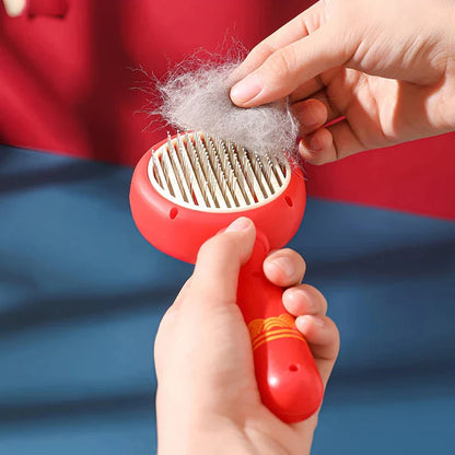 One-Click Pet Hair Removal Comb in red colour, designed to effectively remove loose fur and tangles from cat or dog coats