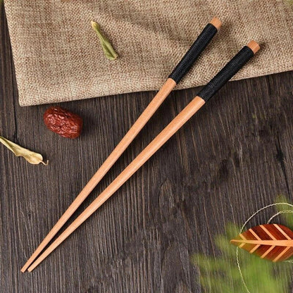 Pair of natural chestnut wood chopsticks with a rustic, earthy tone and elegant design