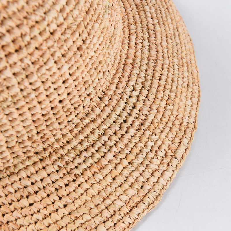 Handcrafted raffia sun hat for women, with a flat brim design and adjustable sizing for versatile sun protection and stylish summer wear