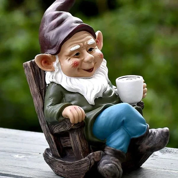 A charming garden gnome ornament made of durable resin, relaxing in a rocking chair and sipping tea, adding a whimsical touch to any outdoor space.