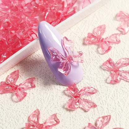 Charming candy-coloured bow nail charms in various colours, perfect for adding a playful touch to your manicure
