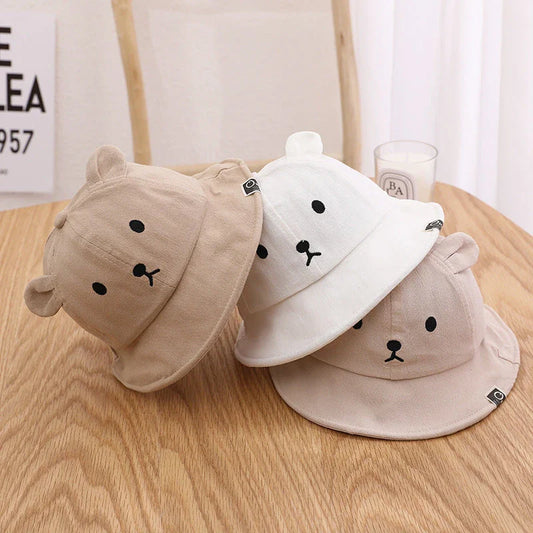 Adorable baby sun hat with cute bear ears, made of soft cotton and durable polyester for sun protection and comfort.