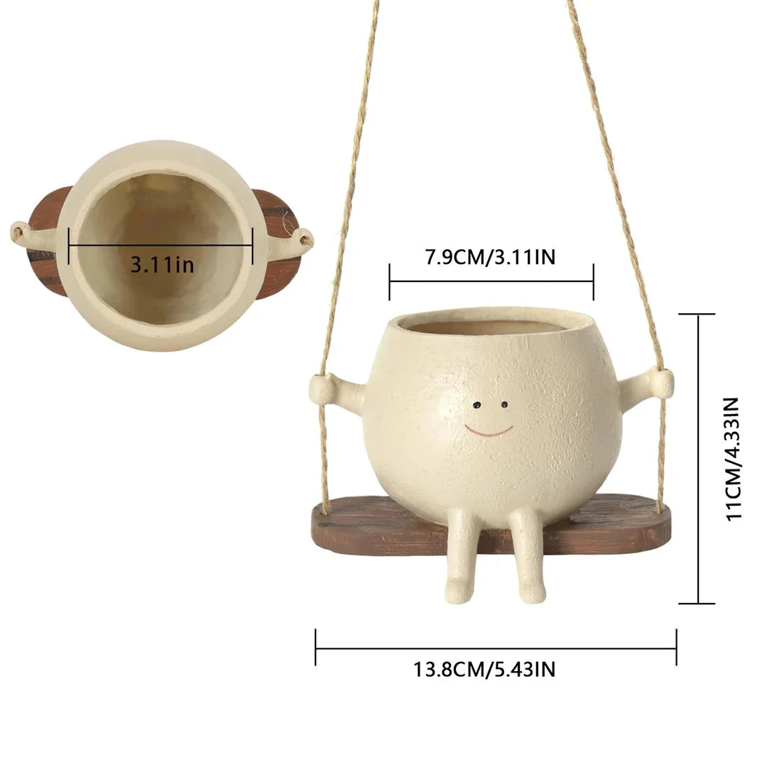 Charming face-shaped wall planter with swing design for hanging flowers, herbs, or succulents in home or garden decor