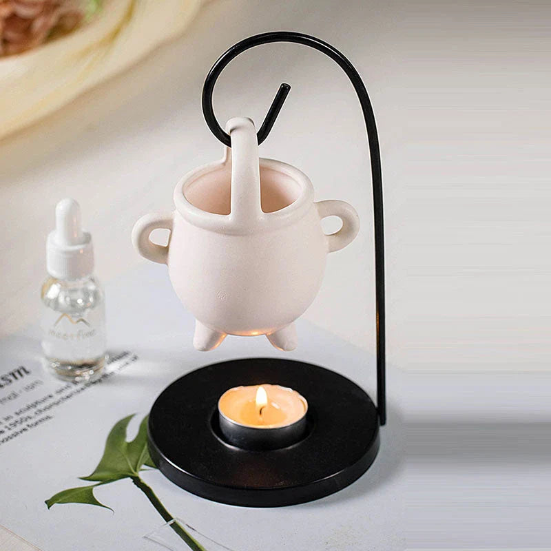 Captivating iron frame essential oil diffuser and candle holder with a unique witch's soup cup design