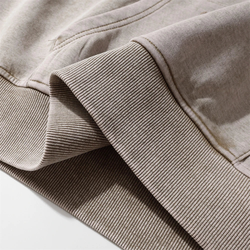 A premium cotton pullover hoodie with an embroidered letter patch in a variety of classic autumn colours