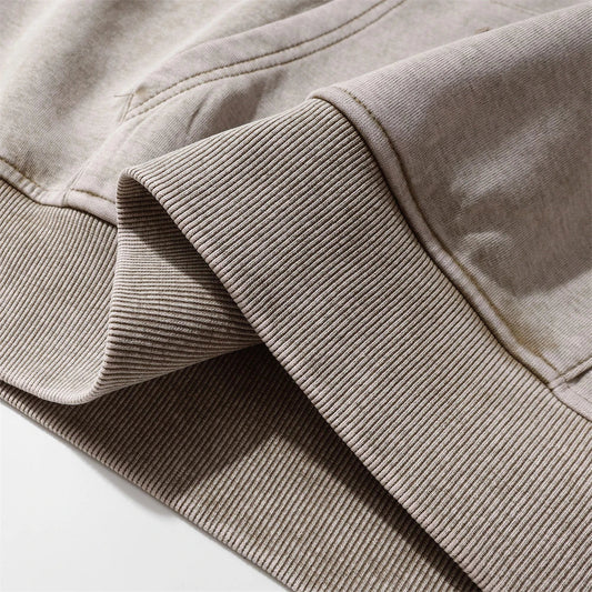 A premium cotton pullover hoodie with an embroidered letter patch in a variety of classic autumn colours