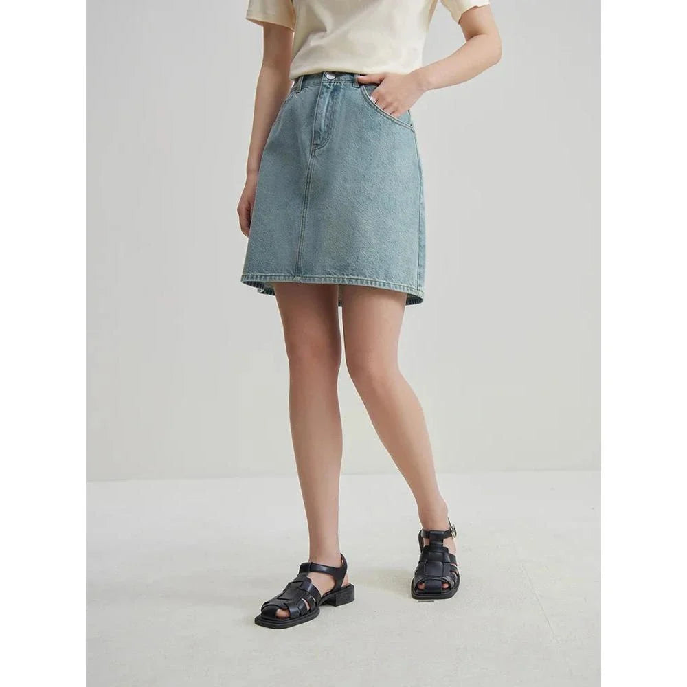 Chic high-waisted denim skirt in a classic blue shade, featuring an A-line silhouette and a flattering empire waistline.