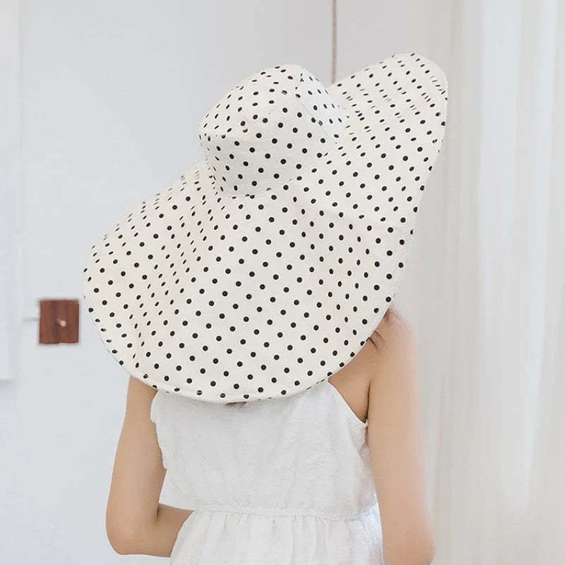 Elegant oversized polka dot sun hat for stylish UK women, offering excellent sun protection and a classic, fashionable design.