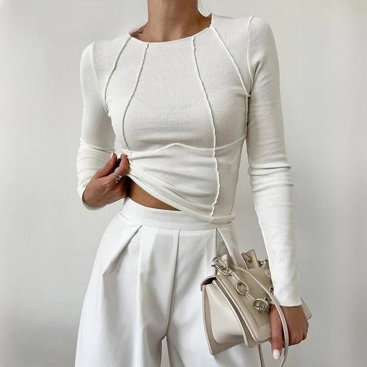 A model wearing a comfortable and stylish long sleeve t-shirt in a solid white colour.