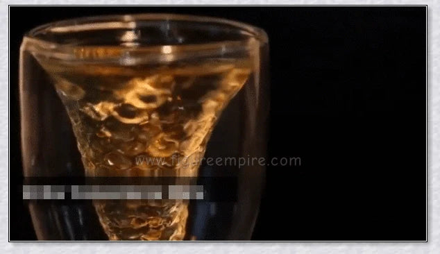 A transparent glass mug with a decorative mermaid tail design, perfect for enjoying a range of beverages in style.