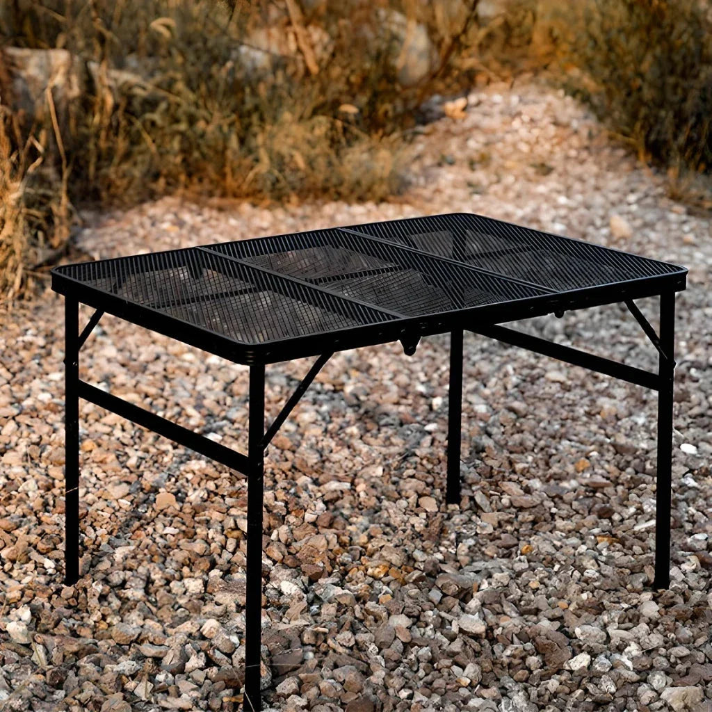 Adjustable portable folding camping table with aluminium frame, black in colour, set up outdoors