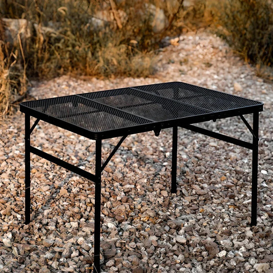 Adjustable portable folding camping table with aluminium frame, black in colour, set up outdoors