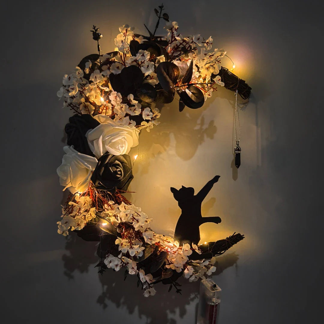Spooktacular Halloween garland featuring a blend of dried white flowers, black roses, and mystical moon cat ornaments