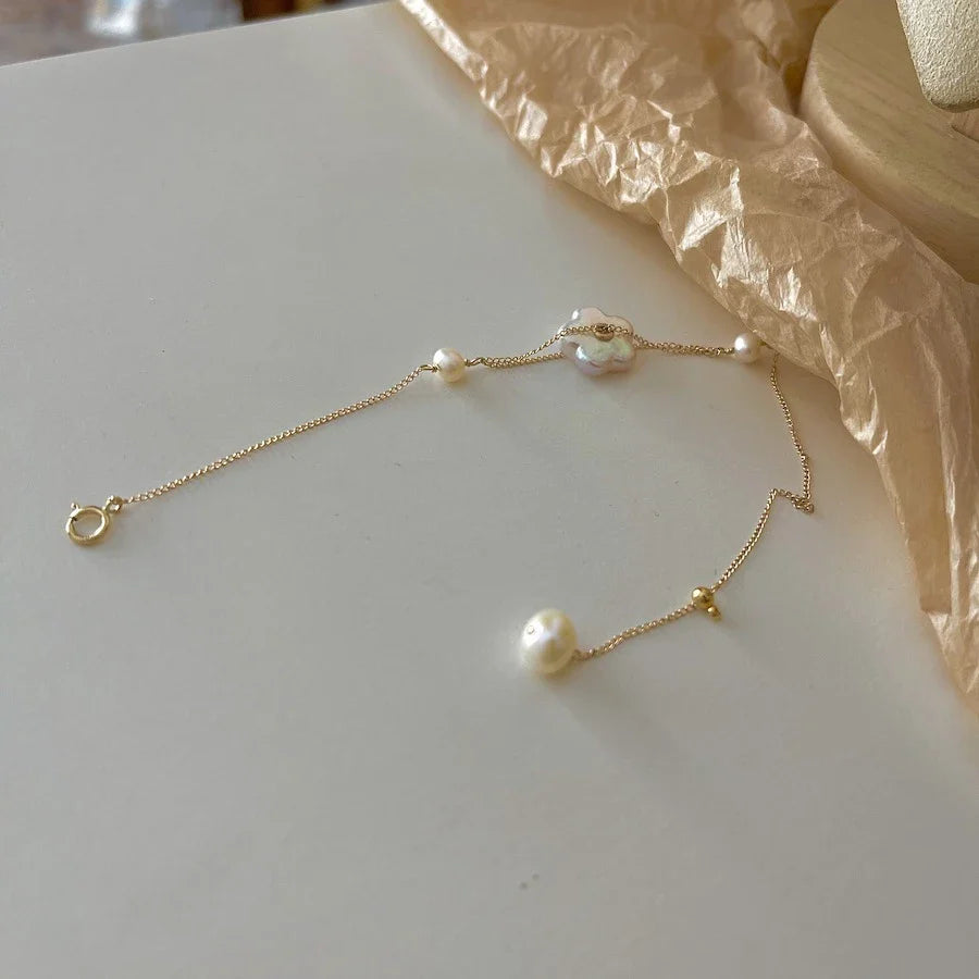Elegant 14K gold-plated bracelet adorned with shimmering freshwater pearls, a timeless British-inspired accessory.