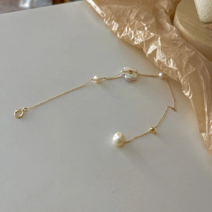 Elegant 14K gold-plated bracelet adorned with shimmering freshwater pearls, a timeless British-inspired accessory.