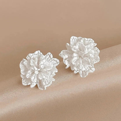 Elegant white floral stud earrings with a unique and captivating design, perfect for fashion-forward women in the UK
