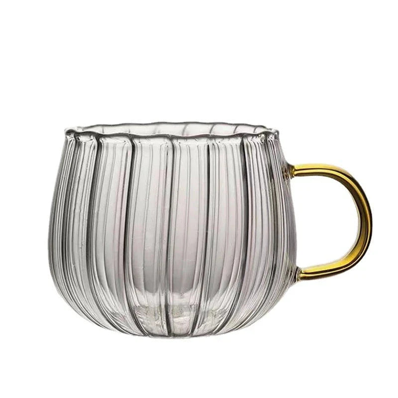 A set of heat-resistant glass mugs featuring a charming pumpkin pattern design, perfect for cosy UK mornings.