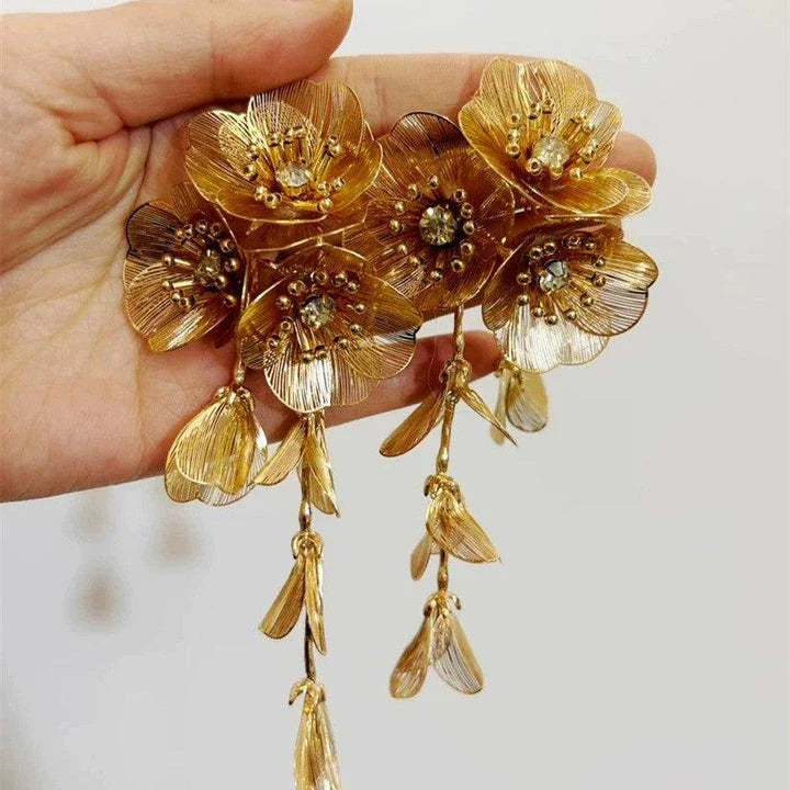 Elegant metal flower charm earrings and necklace set with delicate floral designs and metallic accents