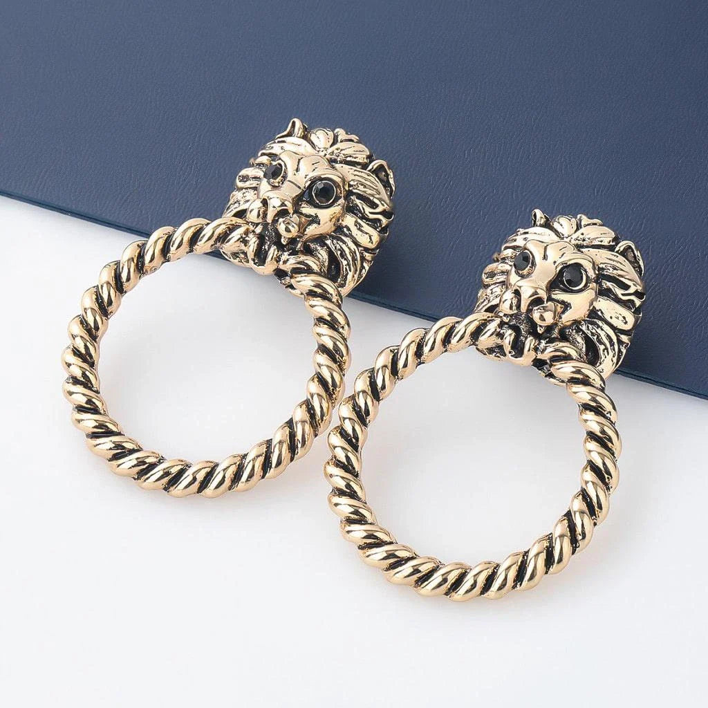 Close-up of the magnificent lion head stud earrings with a twisted hoop design, exuding power and confidence.