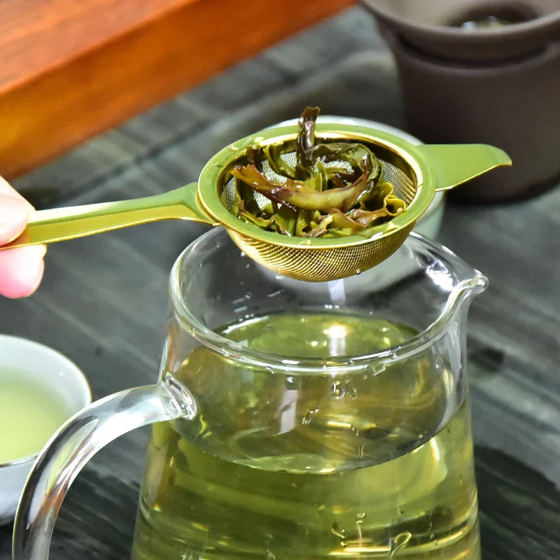 Stainless steel tea infusers with gold-tone finish in a modern, minimalist design