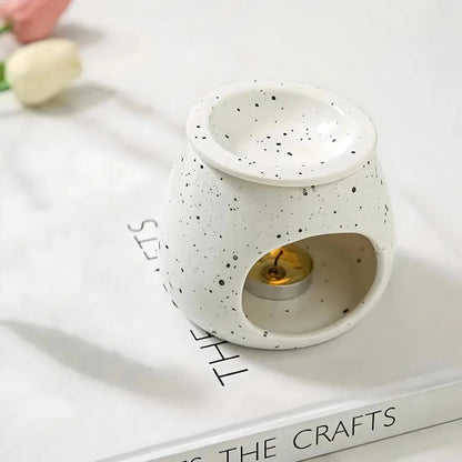 Elegant ceramic aroma diffuser with a unique spotted glaze design, perfect for creating a calming atmosphere in any room.
