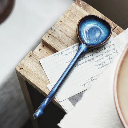 Elegant British ceramic soup spoon with long handle and vibrant glaze for refined dining experience