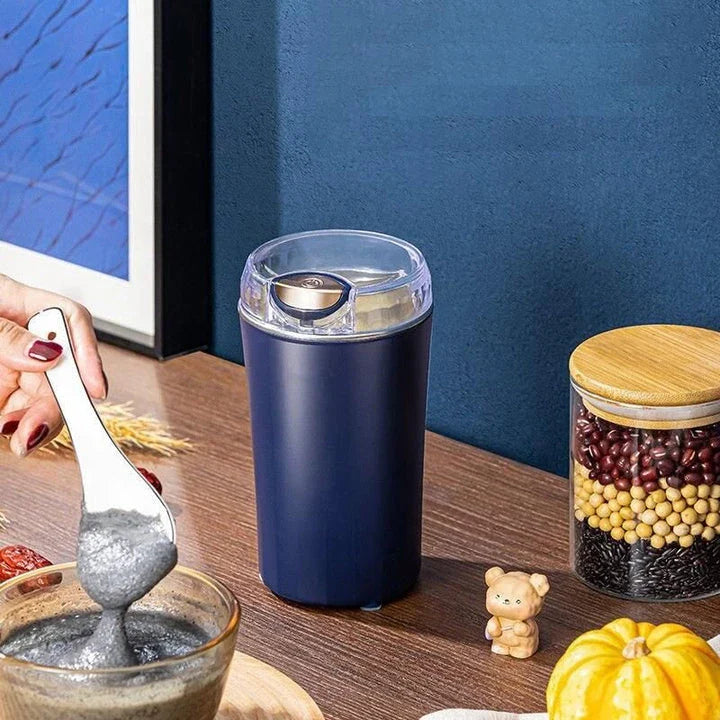 Compact electric coffee grinder with stainless steel blades for fast and even grinding of coffee beans, nuts, seeds, and spices