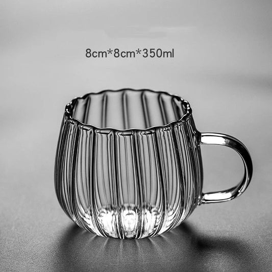 A set of heat-resistant glass mugs featuring a charming pumpkin pattern design, perfect for cosy UK mornings.