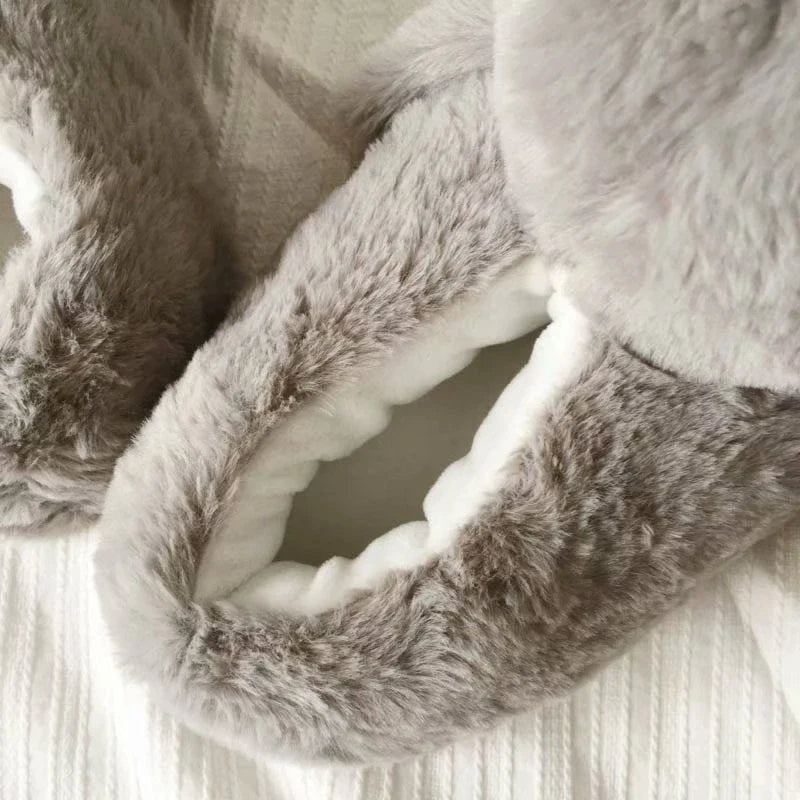 Pair of cosy, plush home slippers featuring a playful penguin design