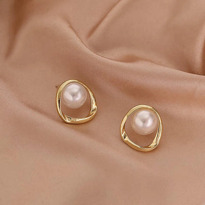 Elegant gold-coloured simulated pearl stud earrings with a distinctive geometric design