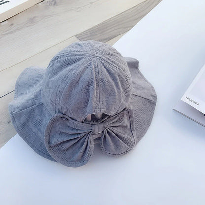 Adorable pink princess baby bucket hat with bow detail for sun protection and fashionable wear