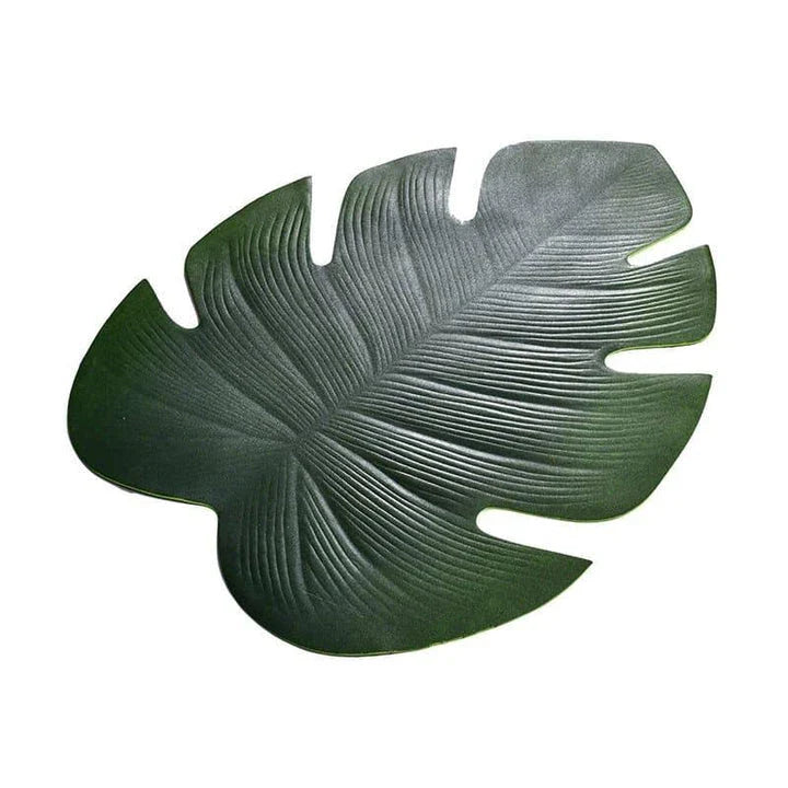 Elegant floral-patterned PVC dining table coaster in a contemporary setting, protecting a wooden table surface