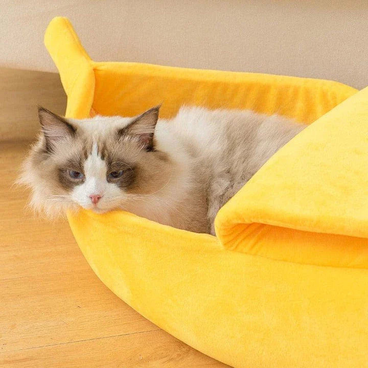 A cosy, banana-shaped cat bed made of plush, supportive materials in various vibrant colours to provide a comfortable and stylish retreat for feline friends.