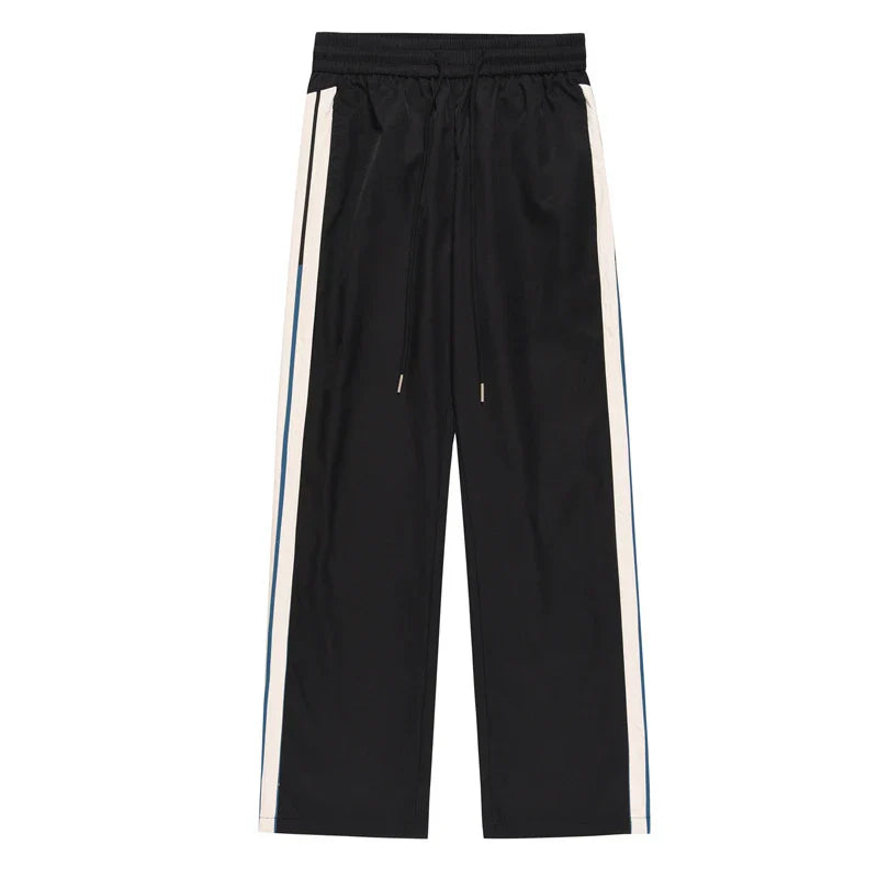 Chic wide-leg trousers in black and dark blue, featuring a draping silhouette and mid-waist design for a sophisticated look.