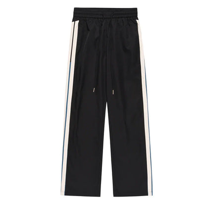 Chic wide-leg trousers in black and dark blue, featuring a draping silhouette and mid-waist design for a sophisticated look.