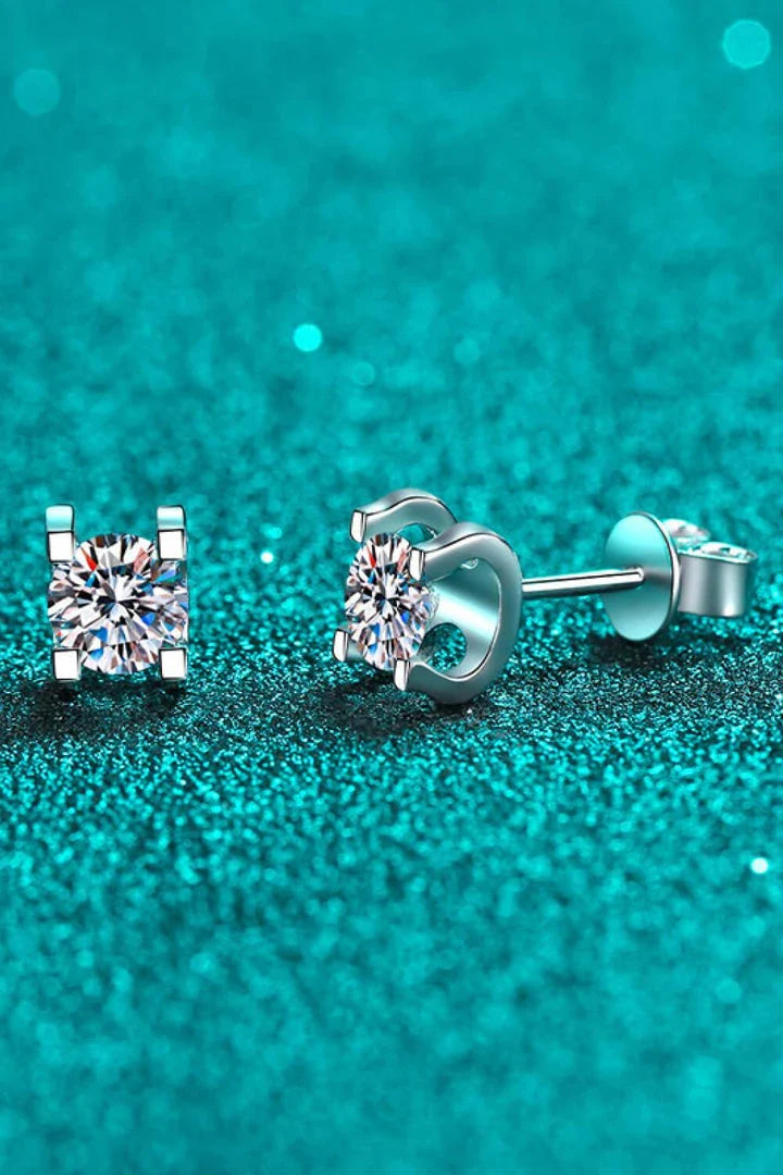 Pair of elegant 1 carat moissanite stud earrings in a minimalist silver setting, perfect for everyday wear or special occasions.