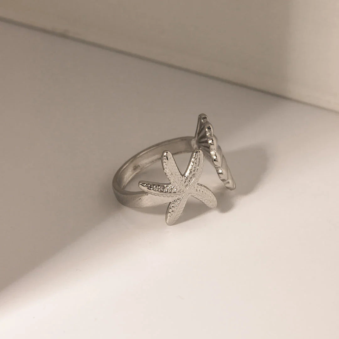 Adjustable stainless steel ring with starfish and shell accents, perfect for beach and casual wear