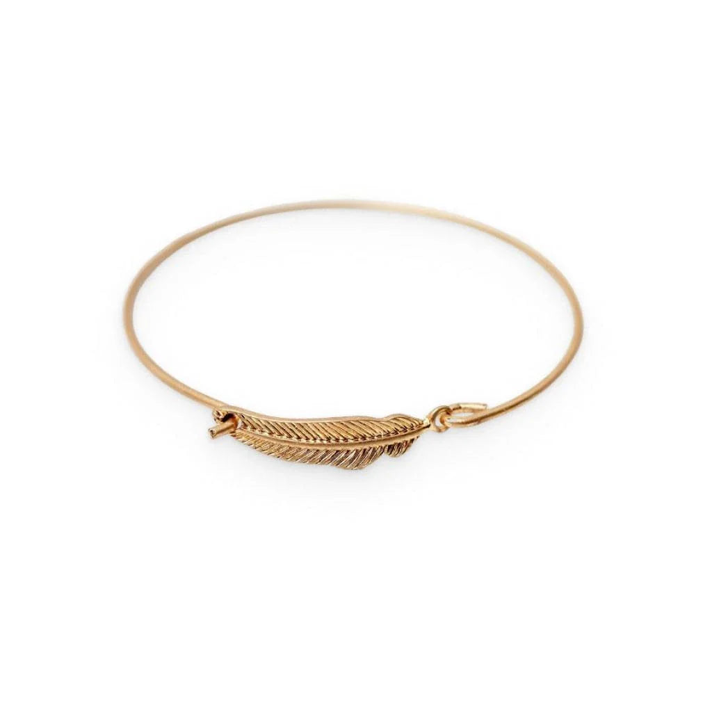 Elegant gold-coloured brass bracelet with a delicate falling leaf design, a nature-inspired accessory for everyday wear