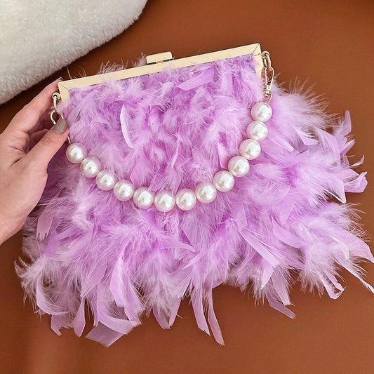 Elegant feather clutch bag with pearls and metal chains, a versatile and sophisticated evening accessory