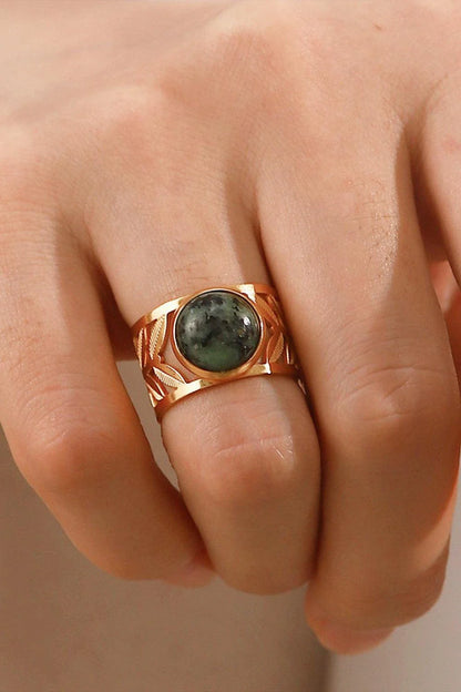 Elegant 18K gold-plated malachite leaf ring in a flat lay, studio style photograph