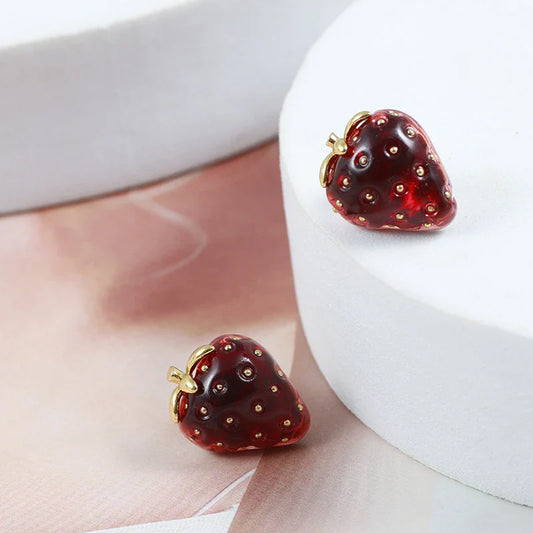 Pair of red resin strawberry stud earrings with a three-dimensional design and secure backing