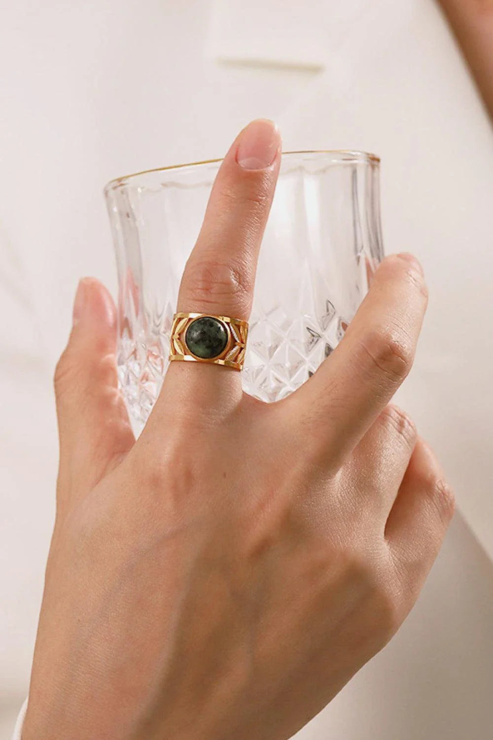 Elegant 18K gold-plated malachite leaf ring in a flat lay, studio style photograph