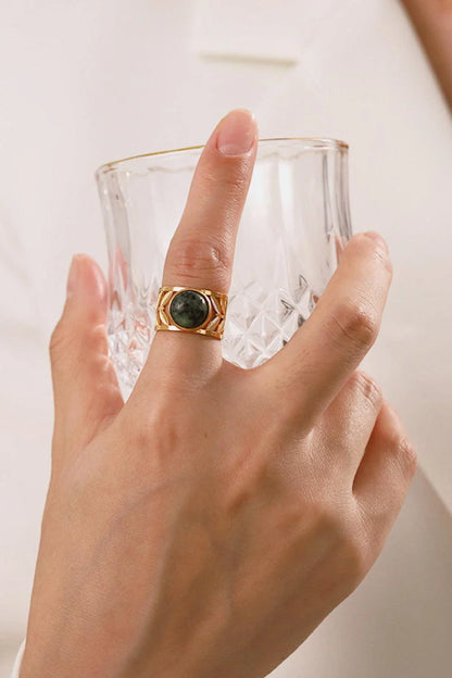 Elegant 18K gold-plated malachite leaf ring in a flat lay, studio style photograph