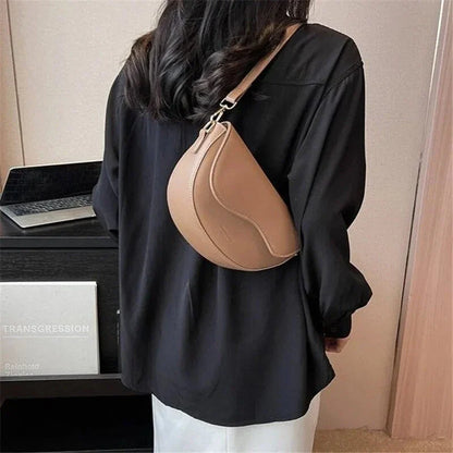A stylish pillow-shaped shoulder bag made of high-quality PU leather, featuring a crossbody and messenger design for versatile use.