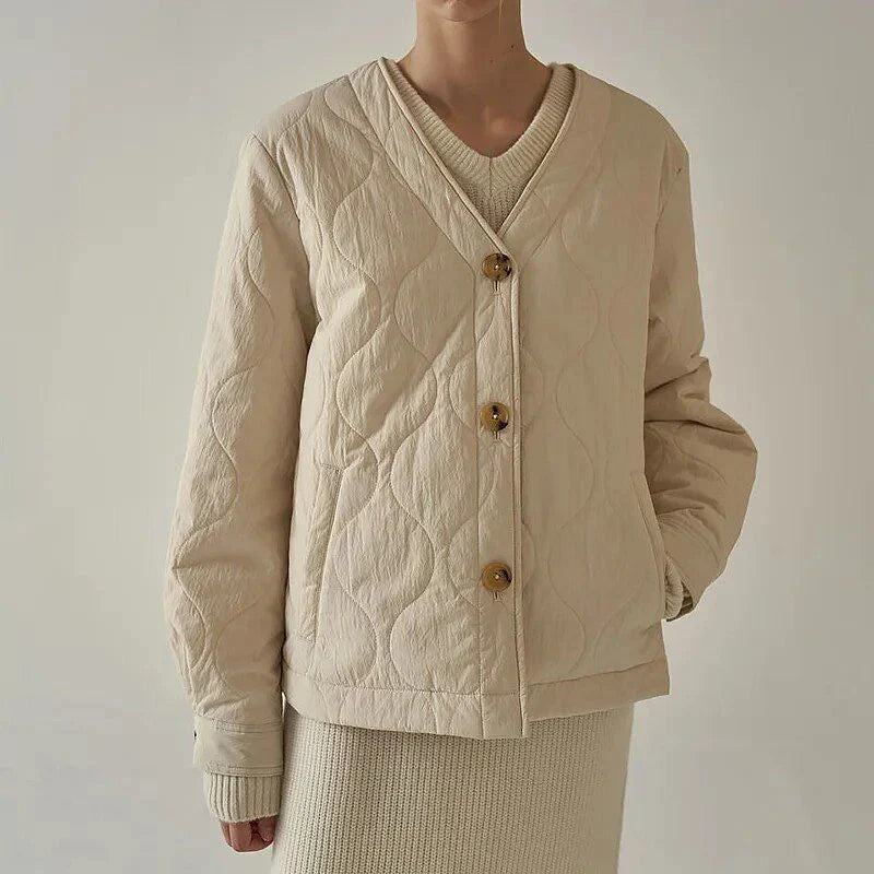 Women's quilted jacket in black, featuring a cosy v-neck collar, button detailing, and a regular fit for versatile winter style.