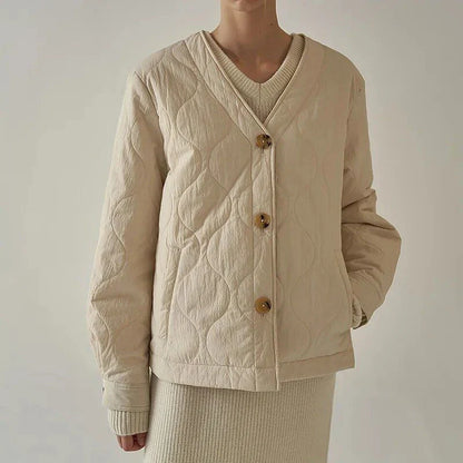 Women's quilted jacket in black, featuring a cosy v-neck collar, button detailing, and a regular fit for versatile winter style.