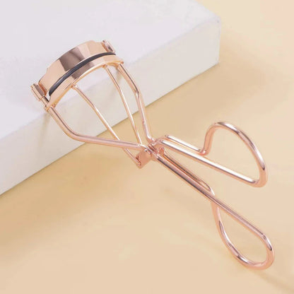 Rose gold eyelash curler with a silicone pad for gentle, long-lasting lash curling