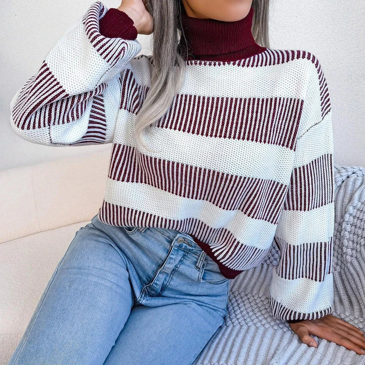 Cosy and stylish high-neck striped sweater in various colours, featuring lantern sleeves and a relaxed fit for all-day comfort.