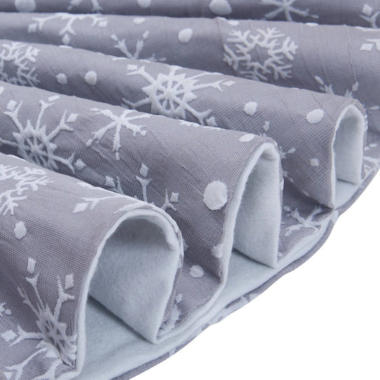 Grey background with intricate white snowflake design Christmas tree skirt
